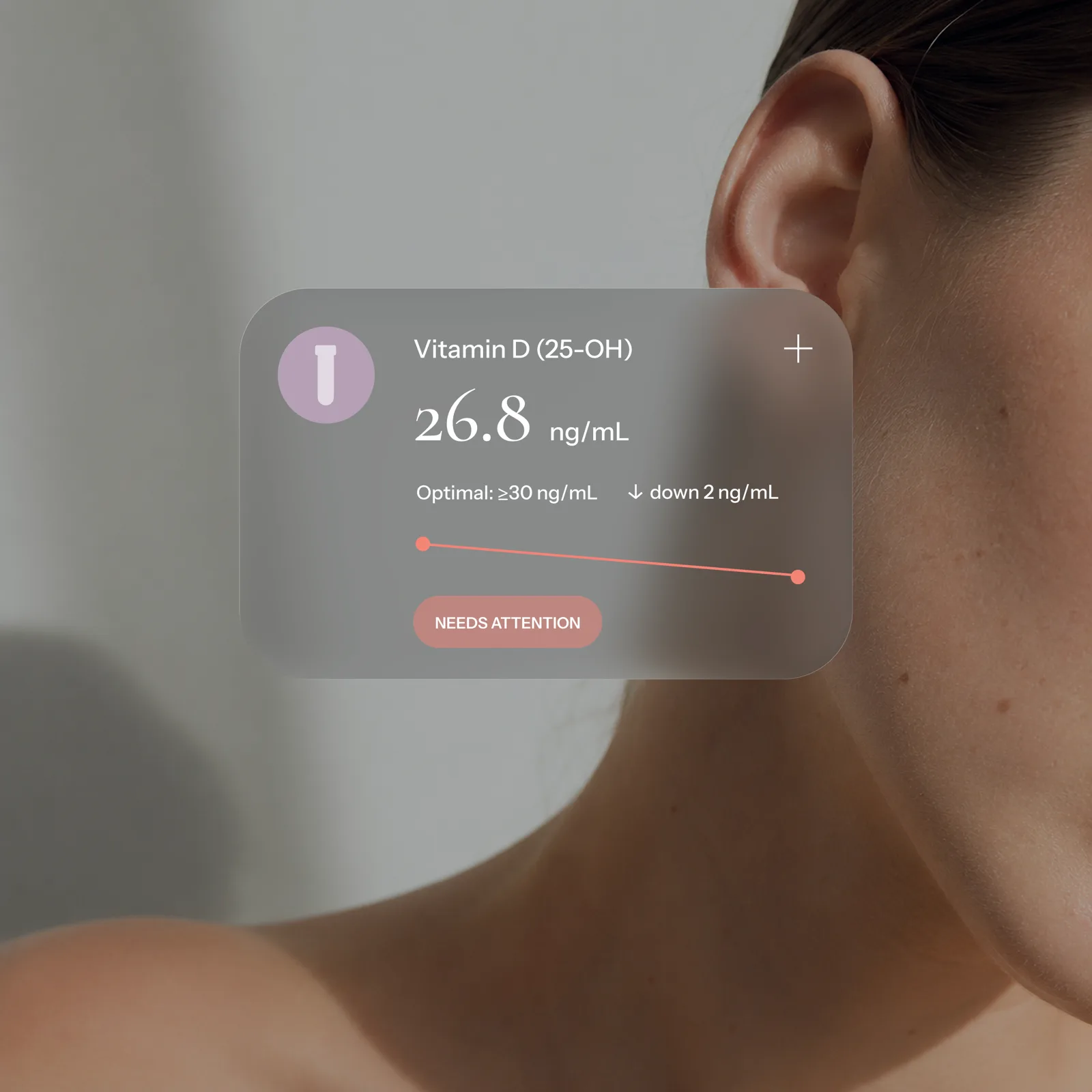 Vitamin D biomarker card over a close detail of a woman's neck and shoulder