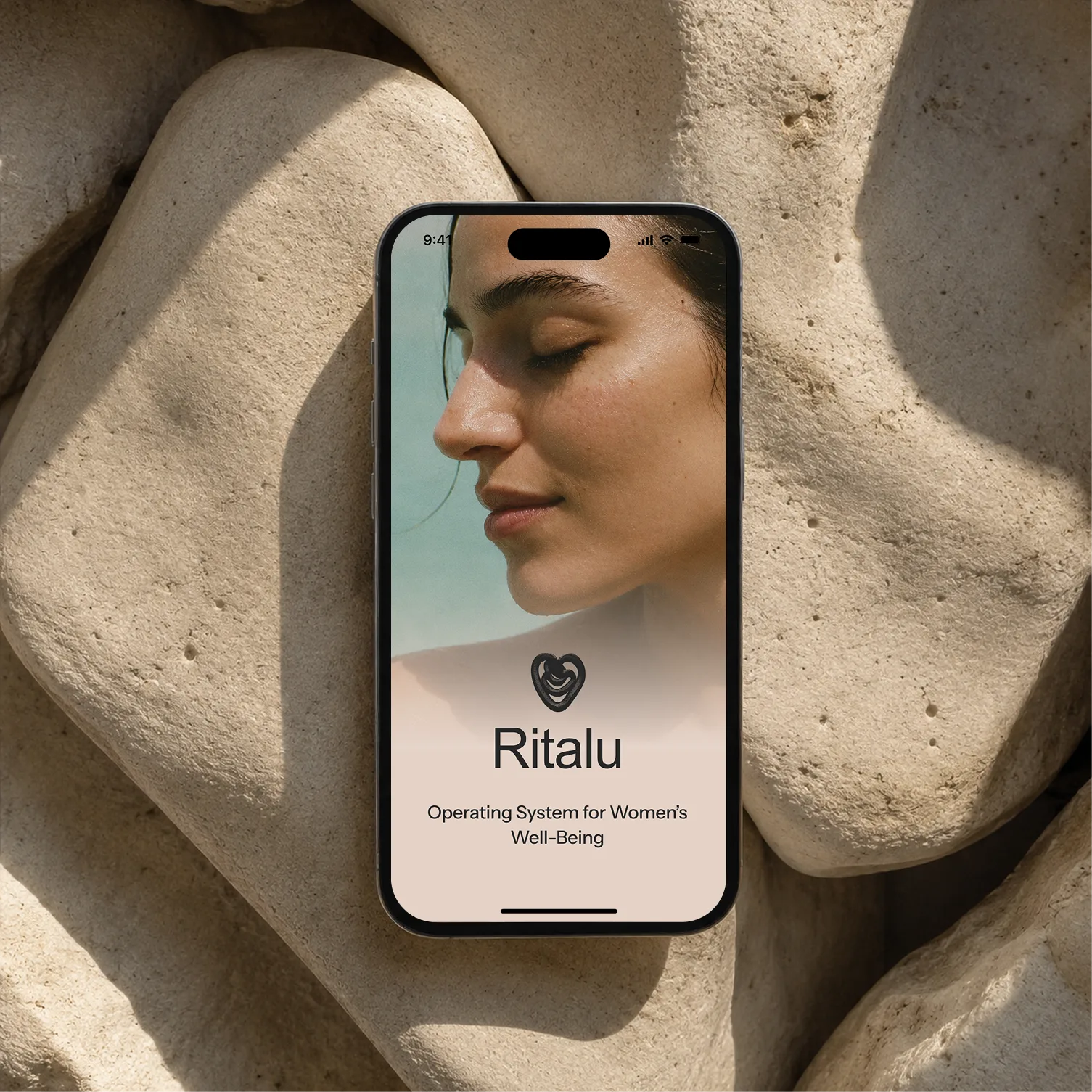 Ritalu app shown on a phone resting on stone