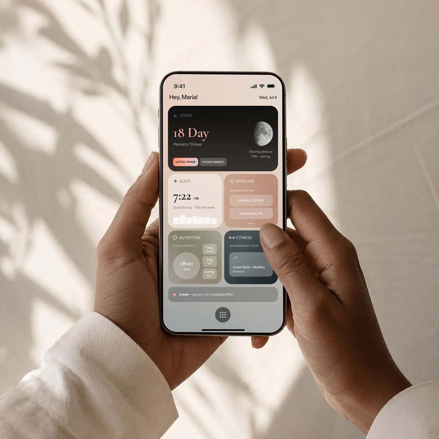 Hands holding a phone showing the Ritalu dashboard